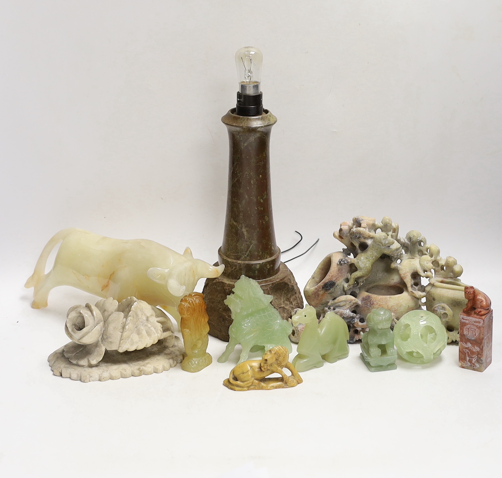 A Cornish serpentine novelty lighthouse lamp and mixed soapstone and hard stone carvings (12), lamp 25cm high